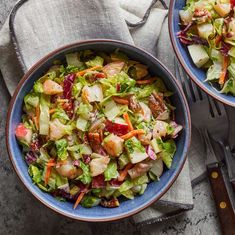 two bowls filled with salad on top of a table