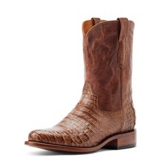 Handsome, rugged, iconic. Younger is the traditional roper boot, elevated. Handcrafted from Caiman leather by expert bootmakers in León, Mexico, this is an ultra-comfortable, premium-quality boot you can wear all day with ease. Bench Made Clanton | Men's Bench Made Clanton in Natural Caiman Belly Leather, Size: 12 EE / Wide by Ariat Goodyear Welted Moc Toe Moto Boots For Ranch, Rugged Fitted Moto Boots For Ranch, Rugged Moto Boots With Moc Toe For Rodeo, Western Work Boots With Goodyear Welt For Ranch, Rugged Fitted Moto Boots With Moc Toe, Rugged Moto Boots With Moc Toe, Rugged Goodyear Welted Moto Boots For Ranch, Rugged Moto Boots For Western-themed Events, Rugged Goodyear Welted Work Boots For Ranch