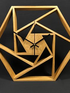 a clock made out of wood on a black background