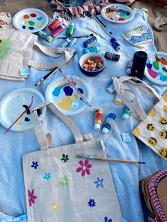 the child is sitting on the bed with her mother's art supplies and crafts