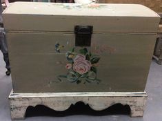 an old chest with flowers painted on it