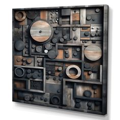 an abstract metal artwork piece with circles and other shapes on the surface, mounted on a wall