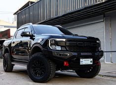 a black truck parked in front of a building