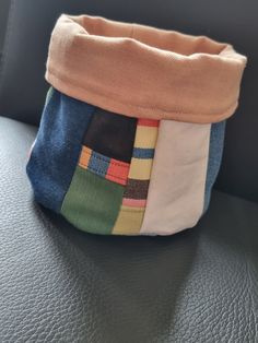 a patchwork purse sitting on top of a couch