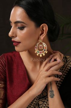 The Gold-plated navrattan chandbali is an ode to the colorful land of India with its joyful hues of red, green, blue, yellow, and white. The navrattan earrings are carefully handcrafted by the artisans to make your look stand out. This Indian navrattan jewelry piece is an elegant replica of Sabyasachi jewelry that you can pair with any ethnic or contemporary ensembles. Closure - Push Back. Style Tip - Since they look very subtle you can mix and match them with any western or traditional wear to Multicolor Chandbali Earrings With Cutdana, Elegant Multicolor Handmade Chandbalis, Elegant Handmade Multicolor Chandbalis, Handmade Multicolor Chandbali Earrings, Multicolor Latkan Earrings For Puja, Multicolor Chandbali Bridal Earrings, Multicolor Chandbalis For Pierced Ears, Fusion Style Earrings For Puja And Festivals, Multicolor Latkans Earrings For Puja