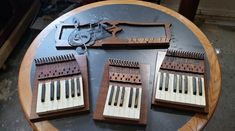 three wooden musical instruments sitting on top of a table