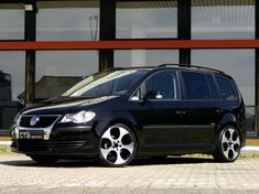 a black van parked in front of a building