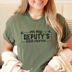 Deputy Wife Comfort Colors Shirt is the perfect gift for any deputy sheriff's wife or wife to be! This shirt runs true to size.  If you want an oversized look, please order one size up.  If you want the oversized dress look, please size up two sizes. Short Sleeve: This is made with a 1717 Comfort Colors, garment-dyed t-shirt. Made with 100% ring-spun cotton, soft-washed, and garment-dyed fabric brings extra coziness to your wardrobe while the relaxed fit makes it an excellent daily choice. The d Deputy Clerk Shirts, Deputy Wife, Leo Wife, Deputy Sheriff, Wife To Be, Comfort Colors Shirt, Oversized Dress, Wife Gift, Dyed Fabric