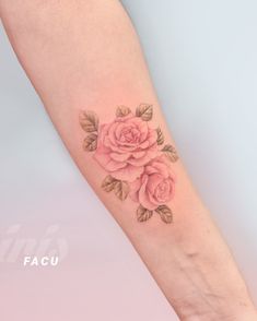 a woman's arm with a rose tattoo on it