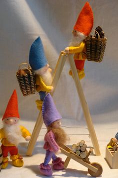 an assortment of gnome figurines on display in front of a white background,