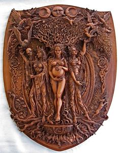 an intricately carved wooden plaque depicting the birth of venus