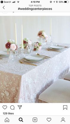 the table is set with place settings and flowers