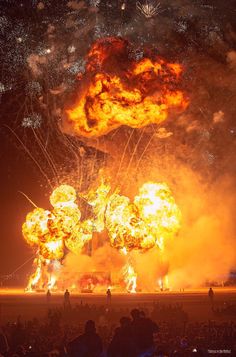 a large group of people watching fireworks in the sky