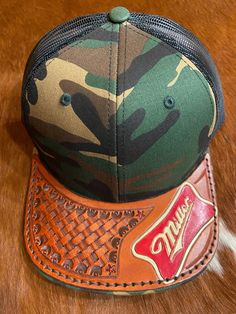 Richardson hat with a hand-tooled leather bill that has been hand sewn to the original bill. Nfr Outfits, Branding Collateral, Richardson Hats, Leather Art, Hand Tooled Leather, Corporate Branding, Tooled Leather, Leather Tooling, Trucker Cap