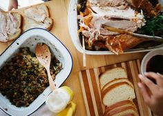 people are sitting at a table with many different foods in bowls and plates on it