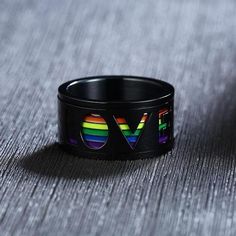 11mm LOVE rainbow design stainless steel men's ring in black and made with high grade 316L stainless steel. Our stainless steel rings are resistant to scratches, dents and corrosion so are durable for years to come and perfect for everyday wear. Spinner rings have a rotatable center moving part which moves around as you rotate and play with it. It's great for fidgety people and also helps with anxiety, stress and nervous tension relief by rotating the ring when these feelings arise. Great unique Princess Diana Ring, Diana Ring, Mens Stainless Steel Rings, Thick Ring, Worry Ring, Lgbtq Wedding, Moss Agate Ring, Fidget Rings, Princesa Diana