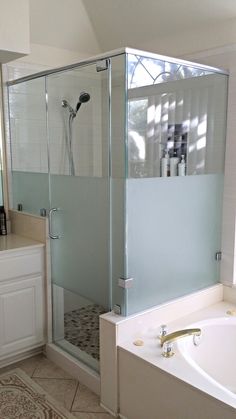 a bath tub sitting next to a walk in shower