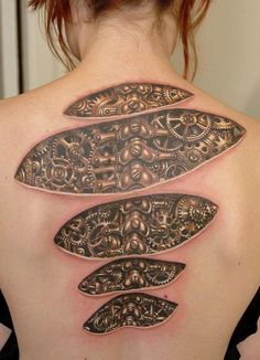 the back of a woman's neck with an intricate design on it