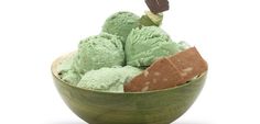 a bowl filled with green and brown ice cream