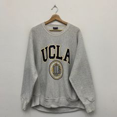 ">>Vintage Ucla Sweatshirt  ** Size on tag : Large ** Measurement on laid flat :  >> Armpit : 23.5\" >> Shoulder to bottom : 28.5\" >> Length sleeve from collar : 30\" ** Great used condition. ** Small stains at front, back and sleeve. ** Overall condition is 8/10. ** Weight : 680g #SW-6" Vintage Long Sleeve College T-shirt, 90s Style Relaxed Fit Sweatshirt For College, Vintage Graphic Print Top For Campus, Vintage Long Sleeve Tops For Campus, Vintage Graphic Print Sweatshirt For Sports Season, Vintage Crew Neck Tops For Campus, Vintage Long Sleeve Sweatshirt For Campus, Vintage Oversized Logo Print Sweatshirt, Vintage Graphic Print Sweatshirt For Campus