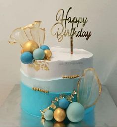 a birthday cake with blue and gold decorations