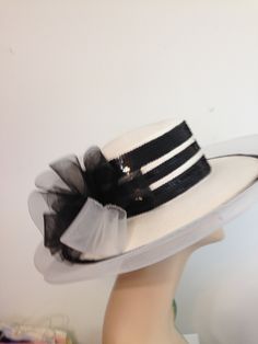 Woman's White Straw Hat with Black Bow and Sequin Trim. 5 Rows of Black and White Sequin around Crown of hat.  Outer brim has 2 rows of black and white sequins with synthetic trim. Bow is sheer Black and White at back. The straw and trim is 100 % Polypropylene.    Lovely Hat.  reminds me of Audrey Hepburn in My Fair Lady, just needs a few more trims. Circumference is 22 Inches (Interior).  Height of Crown is 3 1/2 Inches.   Cartwheel Style -  53 Inch Outer Circumference Ideal for Special Occasion, Tea, Kentucky Derby, or Costume. .. White Sun Hat For Summer Evenings, White Fedora Costume Hat For Summer, White Summer Sun Hat For Evening, White Summer Evening Sun Hat, White Hat Bands For Spring Party, White Fitted Cloche Hat For Beach, Fitted White Cloche Hat For Beach, White Fitted Hat Bands For Party, White Adjustable Sun Hat For Party