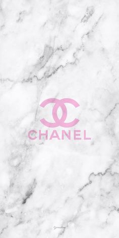 the chanel logo is shown on a marble surface with pink lettering in front of it