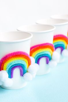 there are three cups with rainbow decorations on them