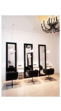 an empty salon with mirrors and chairs on the floor