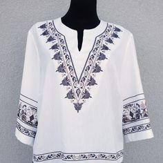 "Experience the freedom and style of our Large Hippie Blouse. Crafted with love and attention to detail, this boho top blouse is the perfect addition to your summer wardrobe. With exquisite embroidery and vibrant colors, it exudes a carefree and joyful vibe that is perfect for any hippie festival or a casual outing. Made from high-quality materials, it offers both comfort and durability. Embrace the bohemian spirit and make a statement with our women's embroidered summer shirt. Elevate your fashion game and feel confident in this unique and eye-catching piece of clothing. Get ready to turn heads and stand out from the crowd with our trendy hippie festival clothes. Very beautiful white with brown/beige colors vintage blouse. Has a producer label. Half long sleeves. A side small slits. The f Summer Embroidered V-neck Peasant Top, Hippie V-neck Blouse For Summer, Bohemian V-neck Blouse With Boho Collar, Summer Boho Print Folk Blouse, Summer Folk Blouse With Boho Print, Summer Folk Style Blouse With Boho Print, Summer Peasant Tops With V-neck, Bohemian Cotton V-neck Top, Folk Style V-neck Top For Vacation