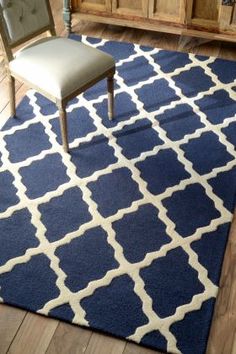 a blue and white rug with a chair on it