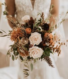 a bride holding a bouquet of flowers in her hands