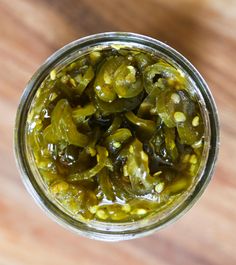 pickles in a jar on a wooden table