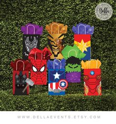 the avengers party bags are all lined up in front of some bushes and bushes with their faces