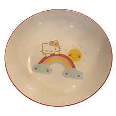 a hello kitty plate with a rainbow and sun on it