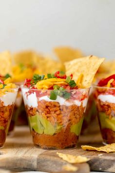 small cups filled with mexican food and chips