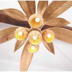 a ceiling fan that has five lights on each of it's four leaves and is hanging from the ceiling