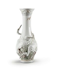 a white glass vase with animals on it