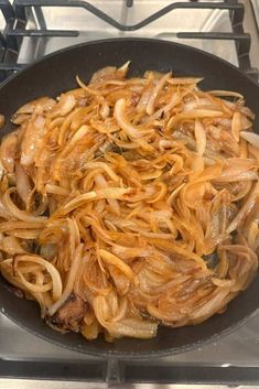 onions are being cooked in a skillet on the stove top, ready to cook