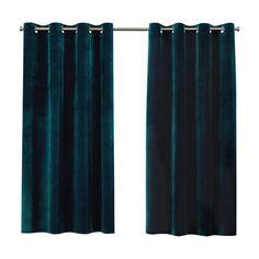 dark green velvet curtains hanging on a curtain rod