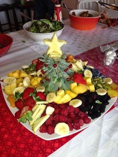 a christmas tree made out of fruit on a plate