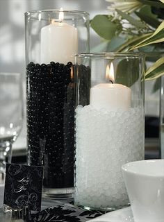 a table topped with candles and vases filled with flowers