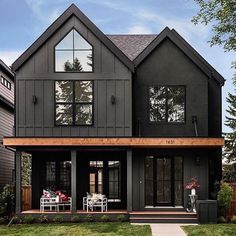 a large black house with lots of windows