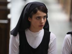 two women dressed in nun costumes walking down the street