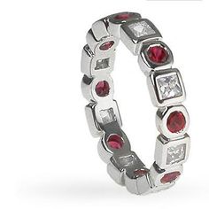 a white gold ring with red and white stones on it's sides, set in silver