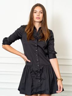 If you are between sizes, we recommend sizing up due to the shorter length of the dress.

 A feminine drop waist shirt dress with our signature No Gape® button up technology.

 Rochelle Behrens reimagined how shirts and dresses should fit and feel. Our patented No Gape® button technology, seamlessly designed into every shirt and shirtdress we design, eliminates blouse gape. Finally say bye bye blouse gape, hello The Shirt.  

  
 * 75% Cotton, 20% Nylon, 5% Stretch 
 * Made in Portugal 
 * Power Dress Drop Waist, Chic Over 50, Event Outfit, The Drop, Dropwaist Dress, Black Shirt Dress, The Shirt, Bye Bye, Drop Waist