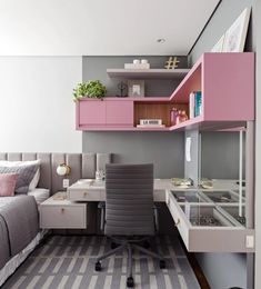 a room with a bed, desk and shelves in it that are pink and grey