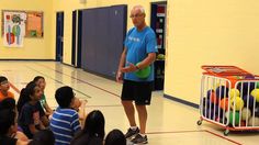 a man standing in front of a group of children