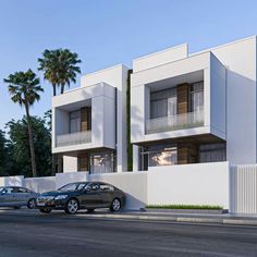 two cars parked on the side of a street next to tall white buildings with balconies