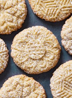 several cookies with powdered sugar on top are arranged in a gridded pattern and placed next to each other